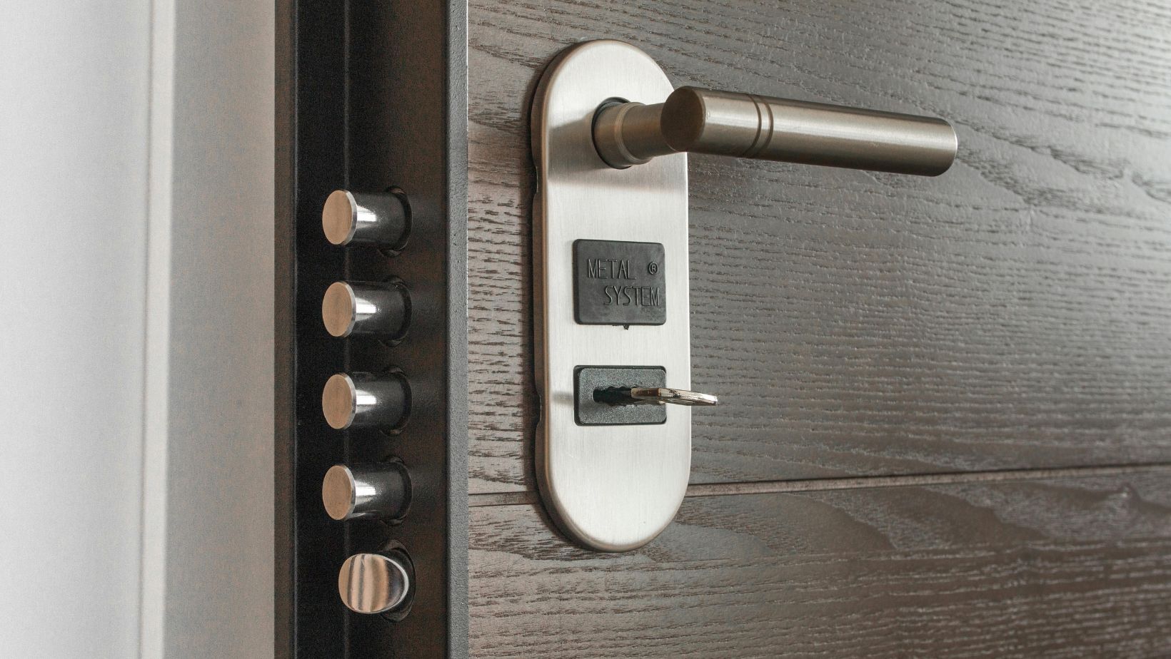 A close-up of a big brown door and the lock system.